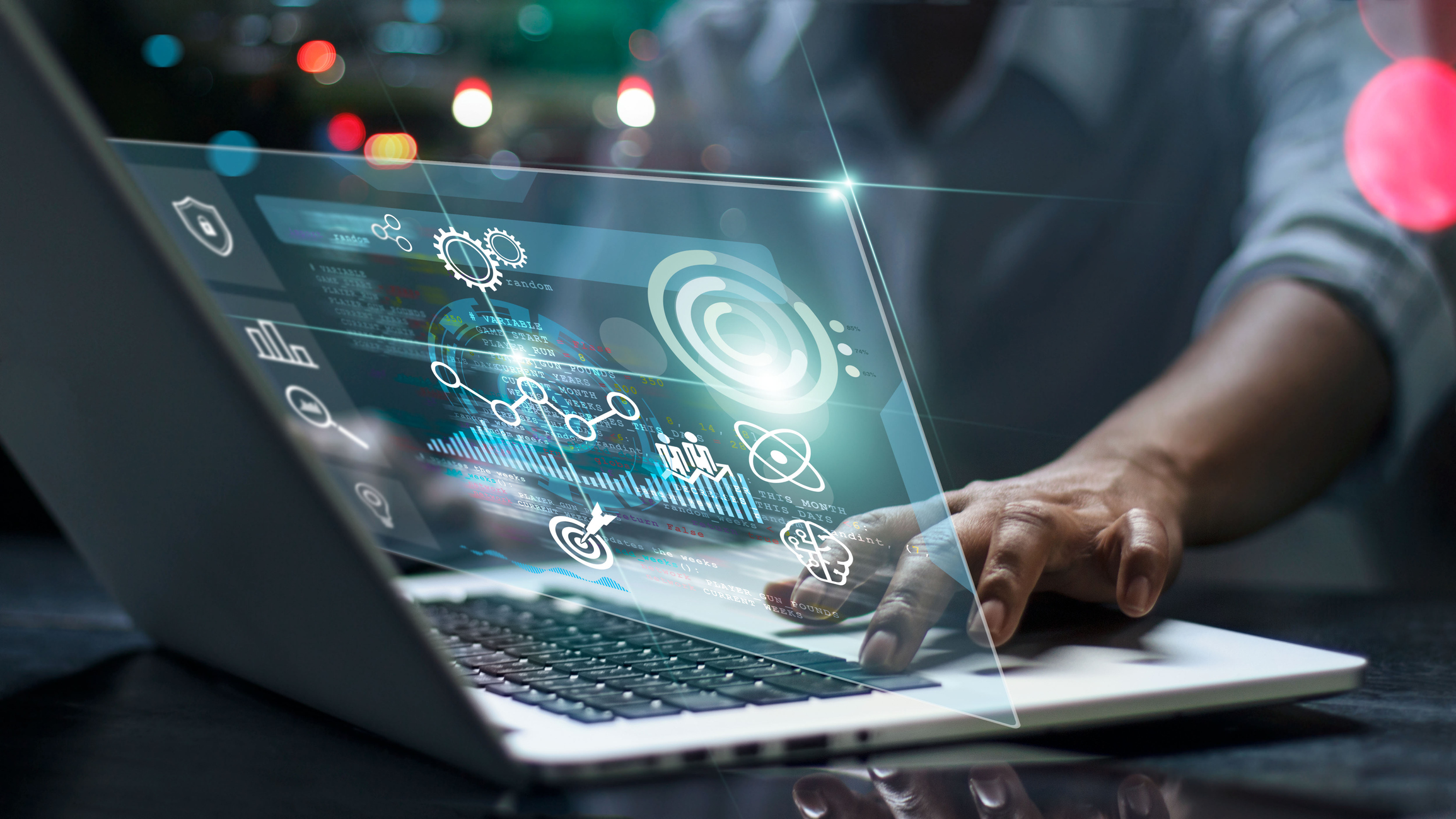 Male working on a laptop to develop a multi-location marketing strategy with various icons floating around the laptop.