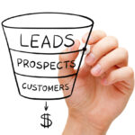 Person drawing a sales funnel representing the lead qualification process using the BANT framework.