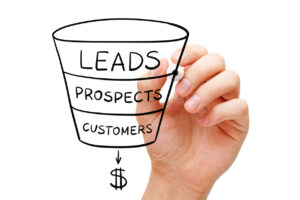 Person drawing a sales funnel representing the lead qualification process using the BANT framework.