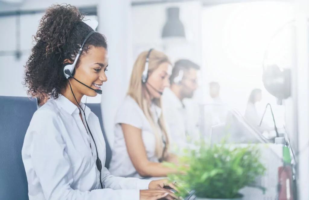 Happy call center agent using a sales call script